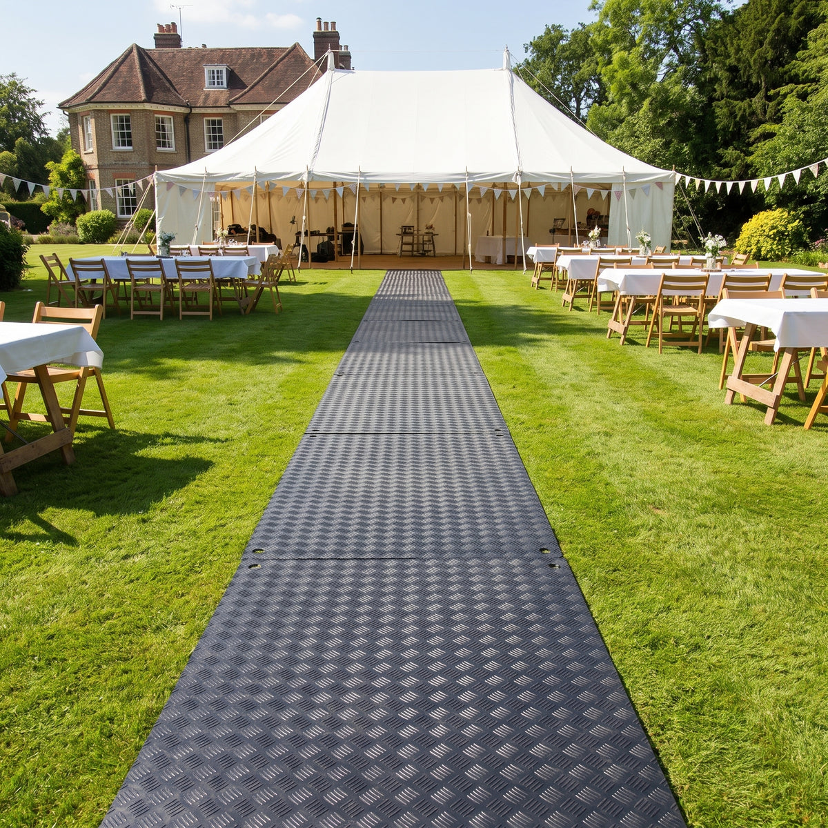 Ground protection boards forming a walkway across a lawn to a wedding marquee