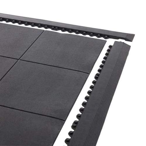 Black ramped edge strips fitted to interlocking rubber tiles to give a tapered edge
